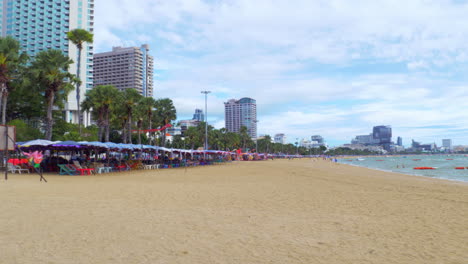 a line of stalls selling a variety of traditional thai food along the beachfront of pattaya beach in chonburi province, thailand