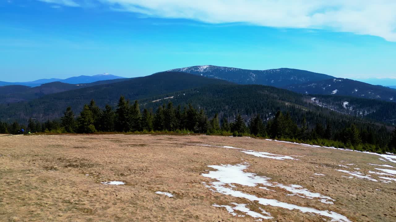 Outdoor hiking at Rysianka mountain pasture on a windy day - drone 4k