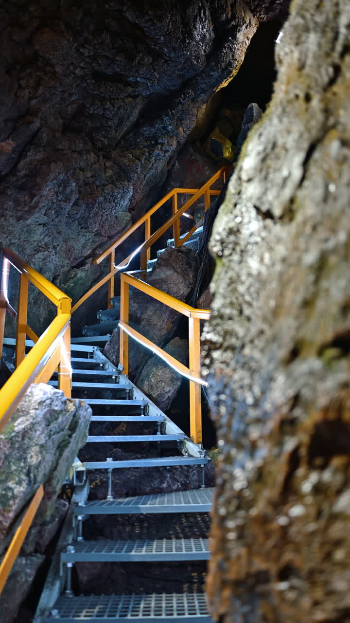 Stairs and rails inside of the Ialomita Cave in the Bucegi Mountains in Romania. Vertical