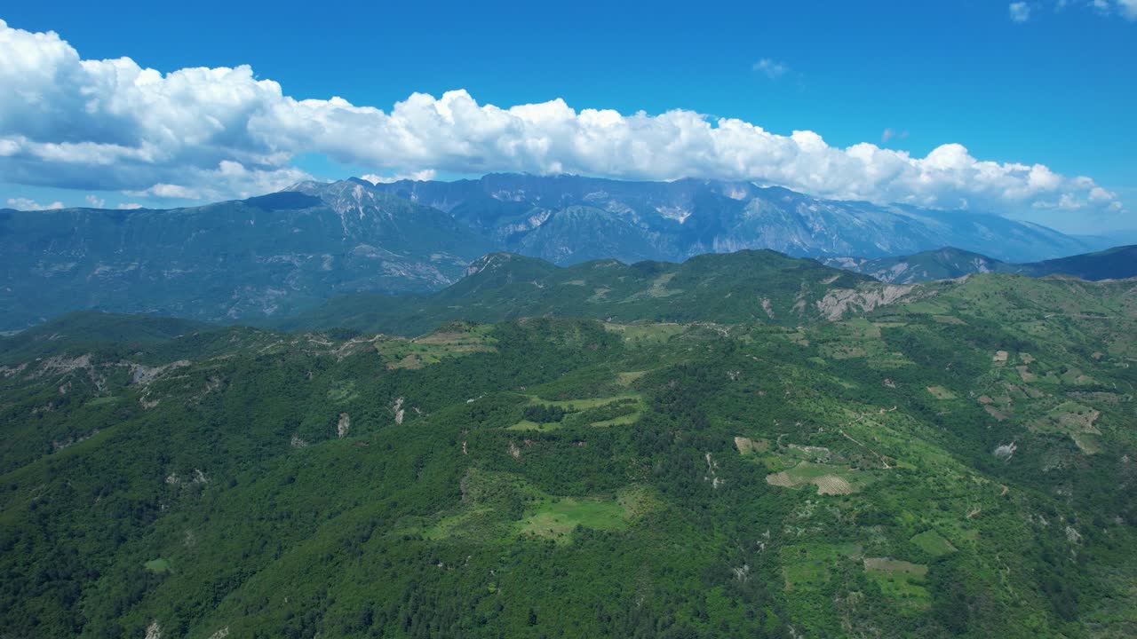 Mountains range covered by white clouds near Leskovik, Albania Greece border scenic spring panorama