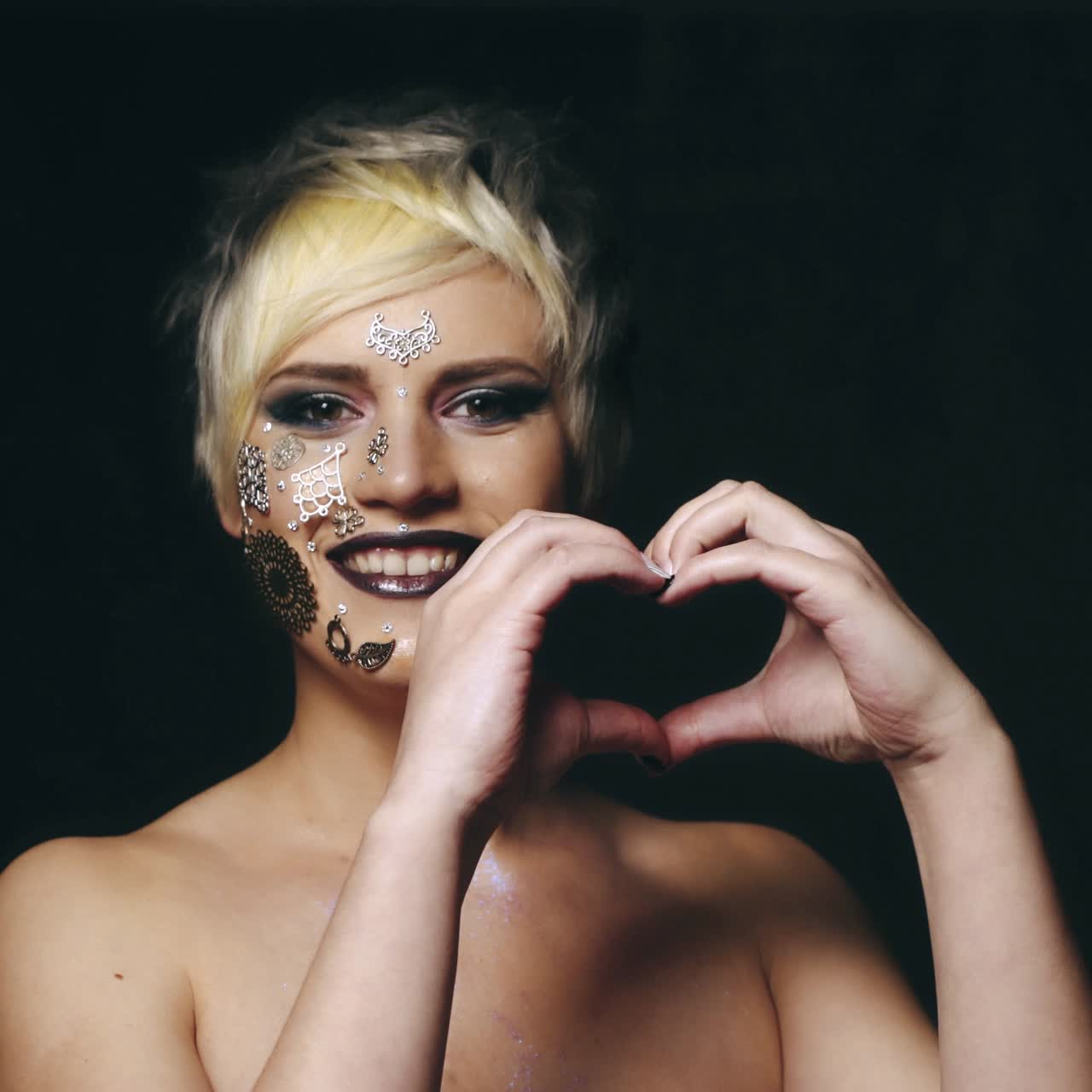 Woman showing heart shaped hands
