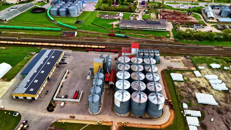 Agriculture silo corn grain harvest industrial storage plant facility, aerial drone