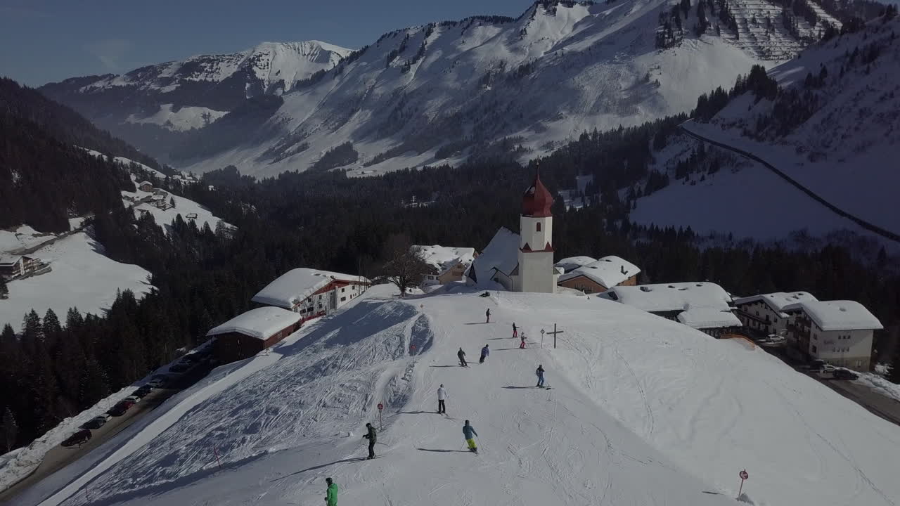 Aerial flight over a ski resort with beautiful church