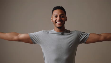 happy man with outstretched arms smiling