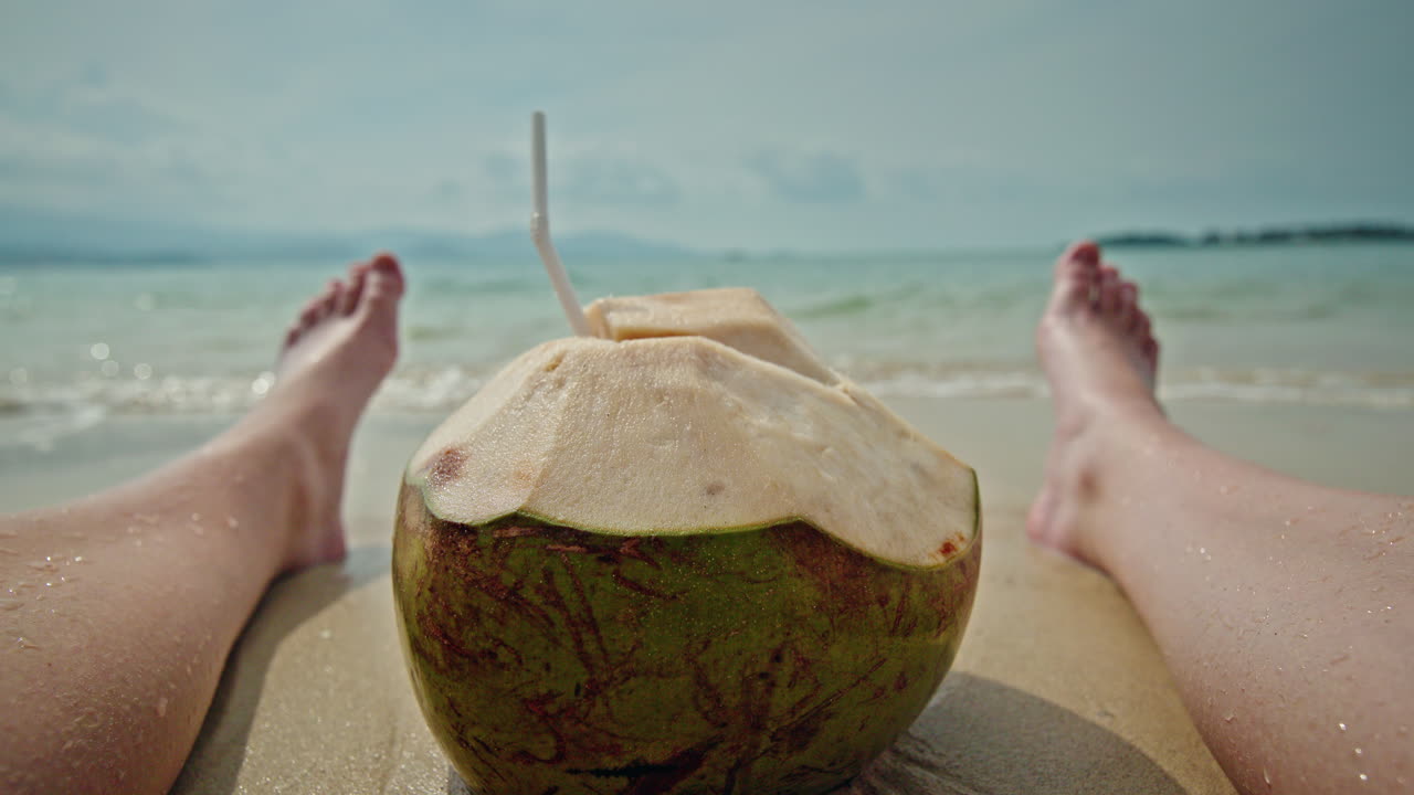 Relaxing on the beach with a coconut