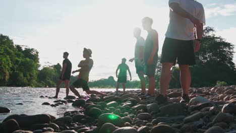 young campers skipping stones in camping trip and enjoying the vacation