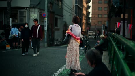 woman walking down a city street in japan