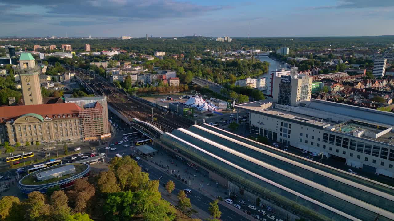 Berlin Spandau train station and Mall shopping center with surrounding urban landscape. Breathtaking aerial view flight panorama overview drone
