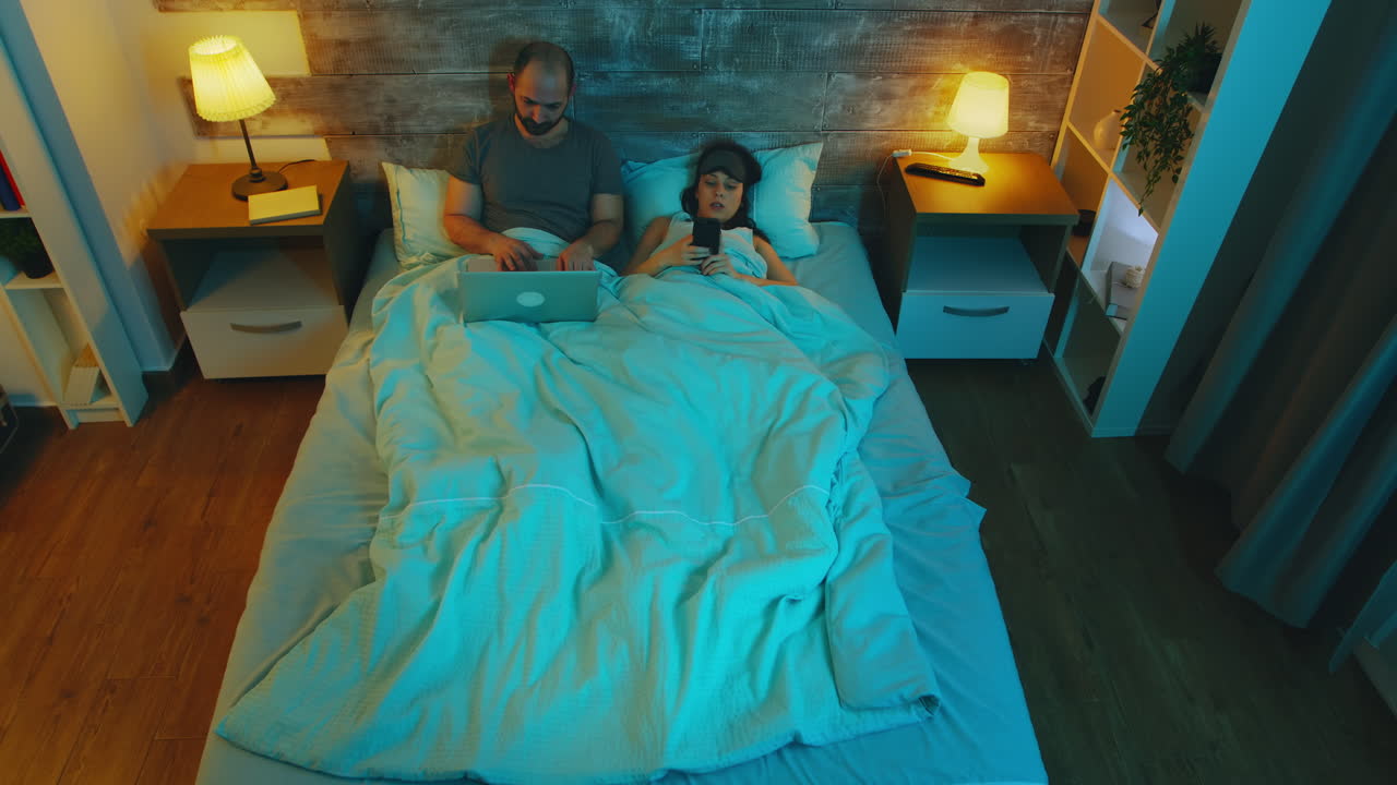 Top view of young couple under the sheets