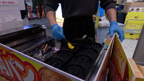 preparing and cooking cheese pancakes at a street stall.