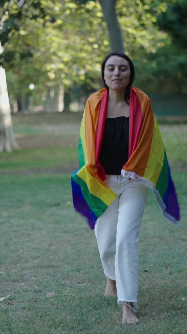 Woman with LGBTQ Flag in Park
