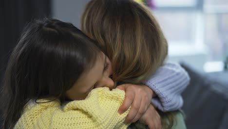 Portrait-of-a-mother-lovingly-embracing-her-daughter