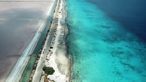 Aerial-view-from-above-of-a-car-traveling-on-a-Bonairean-road-to-the-Salt-Pans