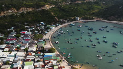 Aerial-view-of-fisherman-village-VInh-hy-bay-in-vietnam-Asia,-fisherman-boats-along-the-coastline-catching-seafood-in-rural-village-ninh-thuan-province,-vietnam