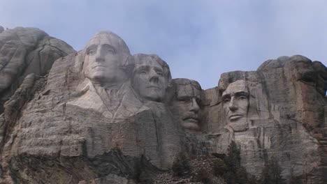 different views of mt rushmore on a cloudy day