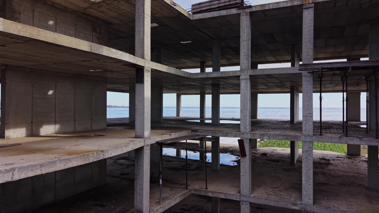 Aerial view of abandoned building with waterfront in the background