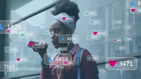 animation of media icons over african american woman talking on smartphone