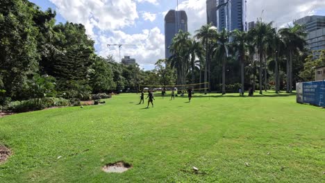 players engaged in a volleyball match in a park