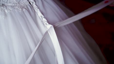 woman getting dressed in a wedding dress