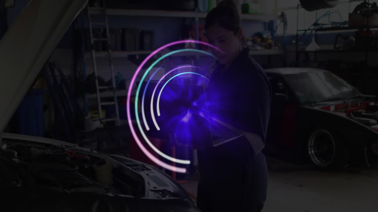 woman mechanic inspecting engine in auto repair garage, interacting with holographic rings