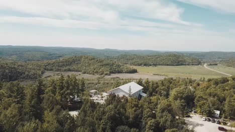 gorgeous sunny day aerial drone clip of the gatineau hills at le belvédère events center in wakefield, quebec