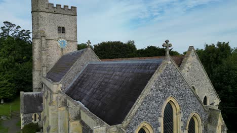 A-rising-boom-shot-of-Holy-Cross-church-in-Goodnestone,-ascending-to-the-steeple