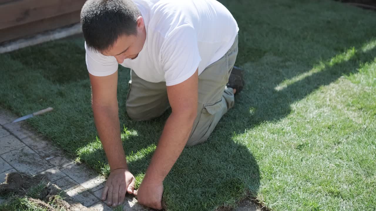 정원사 가 자연 잔디 잔디 를 굴러 놓고 있다