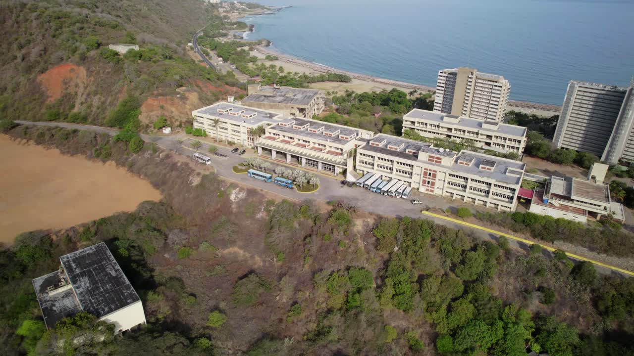 Aerial shot of Universidad Simón Bolívar approaching from a coastal perspective in La Guaira, Venezuela