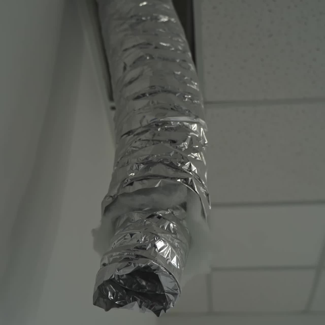 Interior of a room with exposed wiring and ceiling tiles