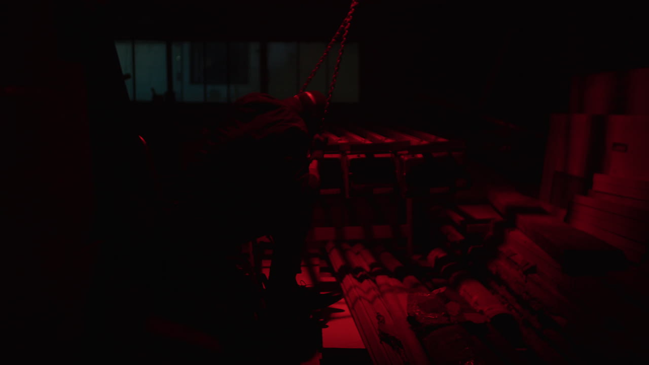Worker in a dark warehouse