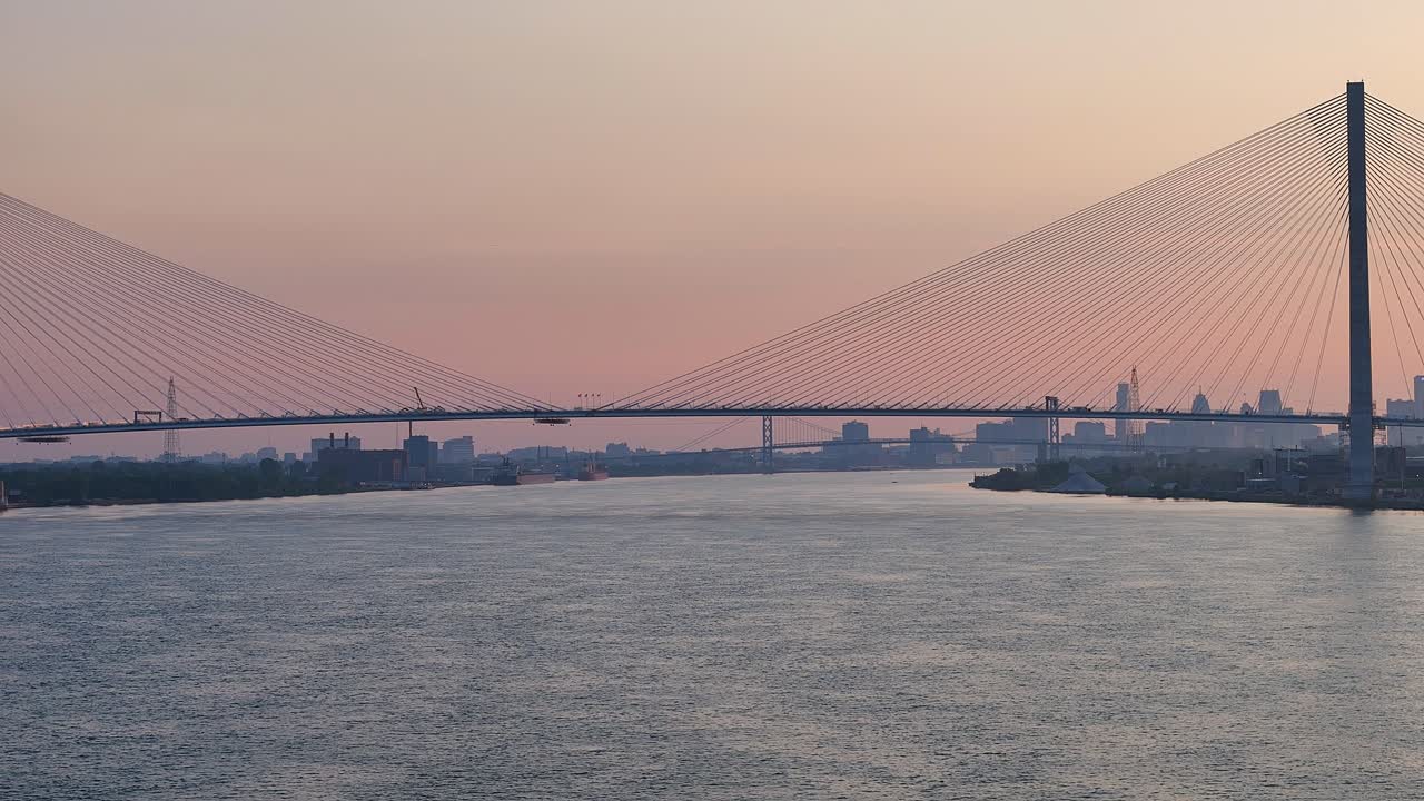 Sunset over Gordie Howe International Bridge with Detroit skyline in background. Aerial panoramic view