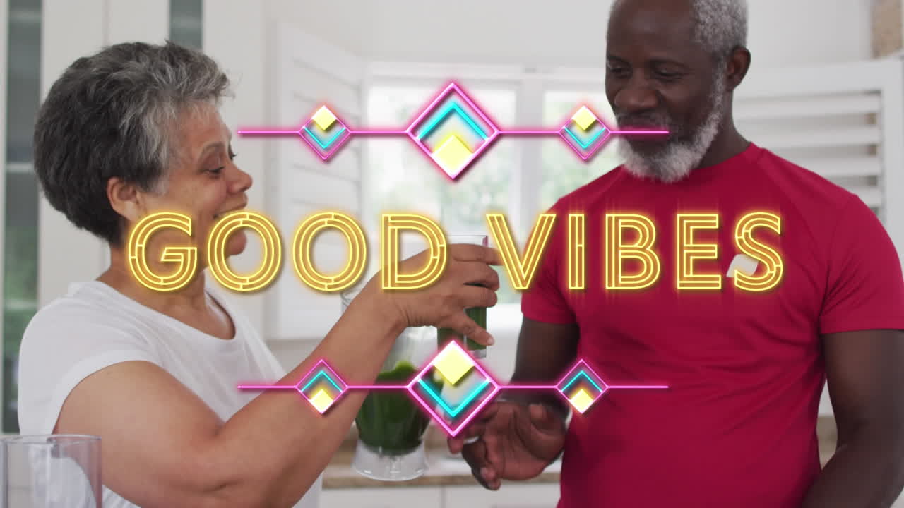 Neon good vibes text against african american woman giving vegetable smoothie to her husband at home