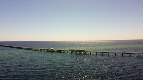 aerial view of busselton jetty with train running along the jetty