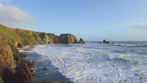 turbulent seas at the copper coast with incoming tide and waves on a crisp winters day after a storm at sea