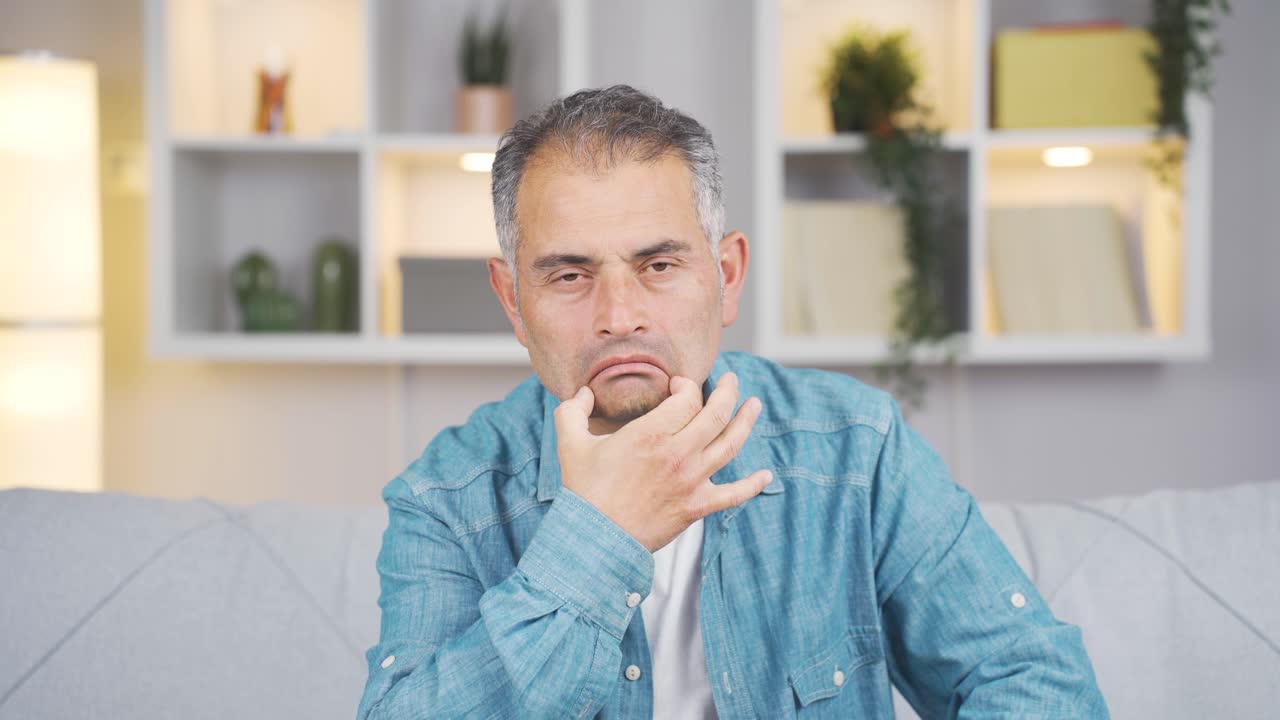 Man looking at camera with a negative expression.