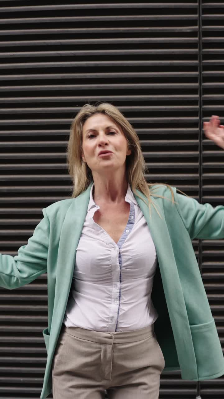 Businesswoman dancing outdoors