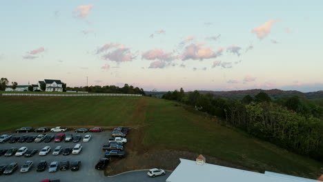Aerial-over-crowded-wedding-venue-at-sunset-in-rural-United-States,-4K