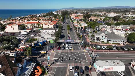 drone rotating shot over the main crossing in carlsbad, california, usa on a bright sunny day with the view of the blue ocean in the background