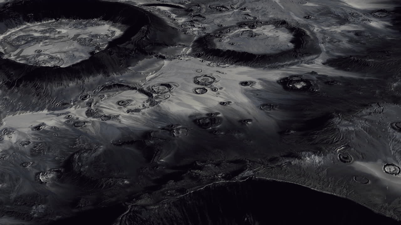 Detailed view of lunar surface showcasing craters and shadows at night