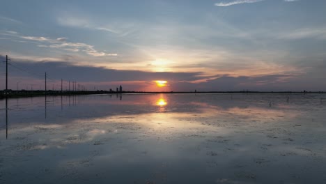 Aerial-view-of-a-sunset-near-Spanish-Fort-over-Mobile-Bay,-Alabama