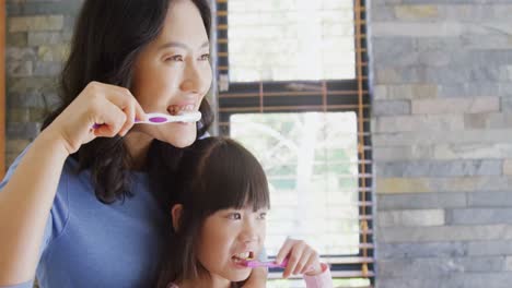 mother and daughter brushing teeth in the bathroom 4k