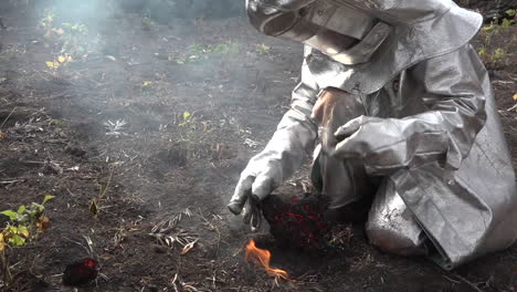 A-man-in-a-fireproof-suit-examines-lava-flows-from-the-Cabo-Verde-volcano-erupts-on-Cape-Verde-Island-off-the-coast-of-Africa