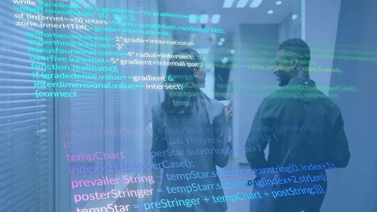 Coworkers walking down corridor exchanging cup while discussing tech project with scrolling code