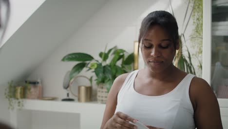 African-American-woman-feeling-fresh-after-applying-roll-on-antiperspirant.