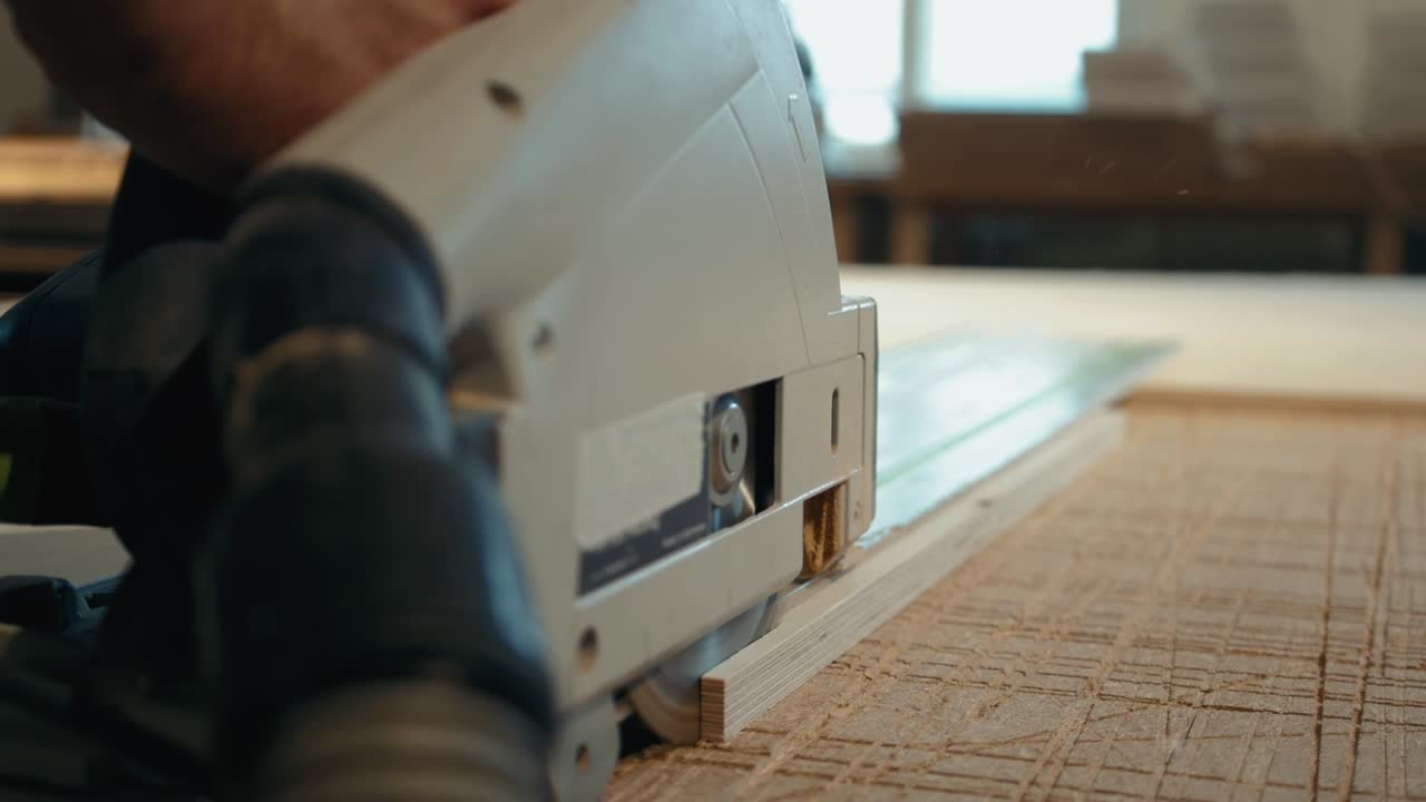 Close up of Carpenter's hands cutting wood with table saw in workshop, craftsman furniture