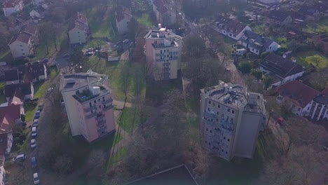 aerial top down of three old urban high rising tower blocks in poor district of germany big city