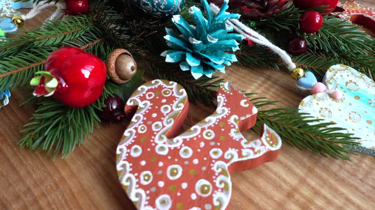 Close-up of Festive Christmas Ornaments and Pine Branches on Wood