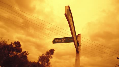 Road-sign-in-Kaukapakapa,-New-Zealand-during-Aussie-bush-fire-against-red-clouds