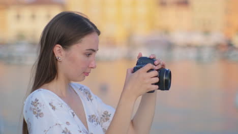 woman taking a picture in a beautiful port city