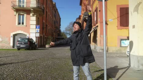 person hails a taxi in an italian city